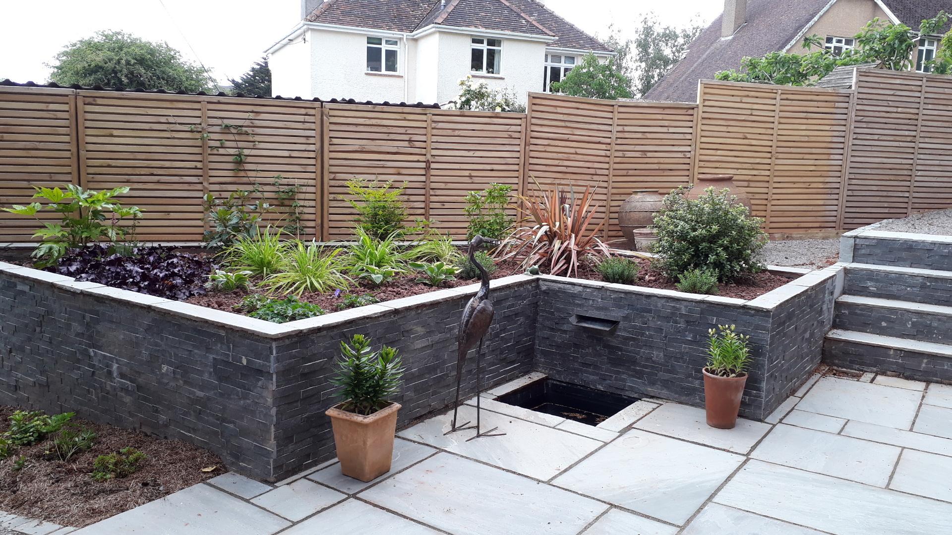Alison Bockh Garden Design and Landscaping - North Devon - raised beds and leat in upper corner and steps to entrance